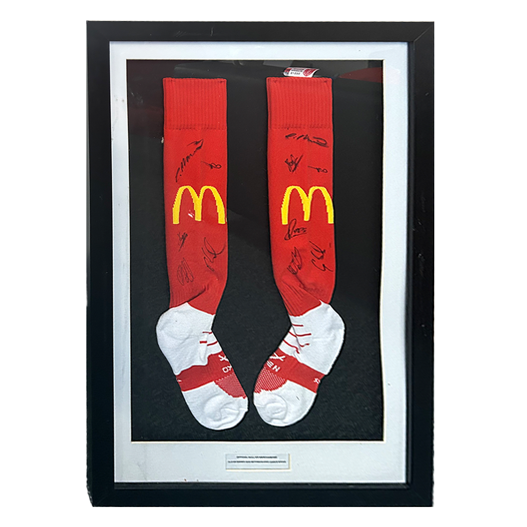 PLAYER SIGNED FRAMED 2021 HOME KIT SOCKS - AUCTION